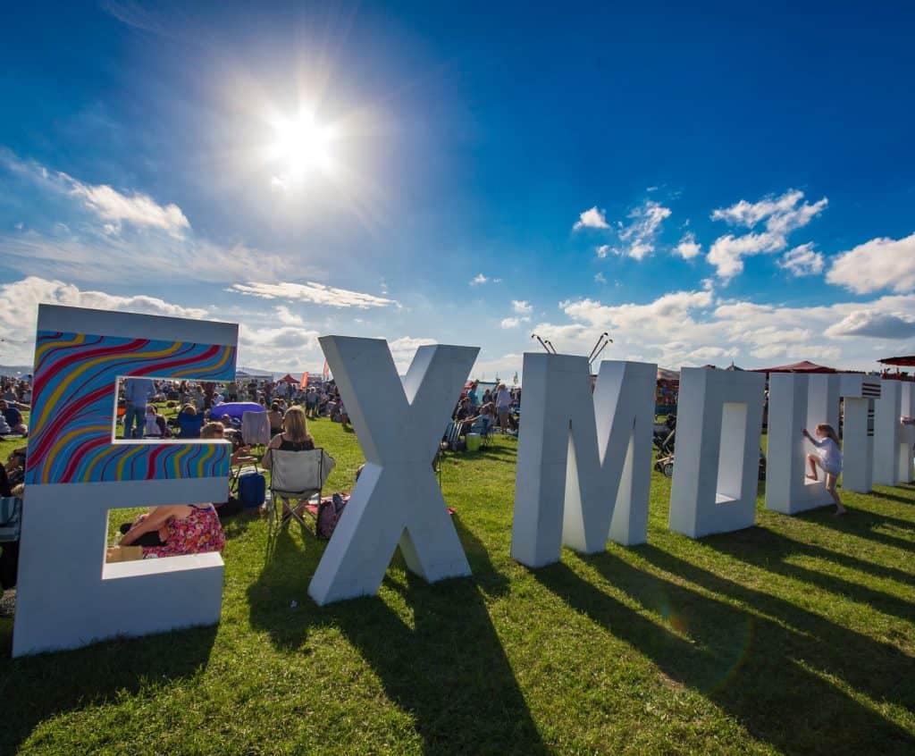 Huge Exmouth sign on grass at festival