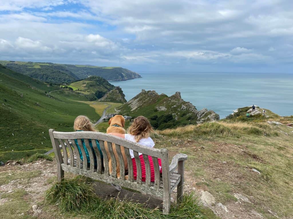 Children and dogs on bench at the top of the Valley of Rocks