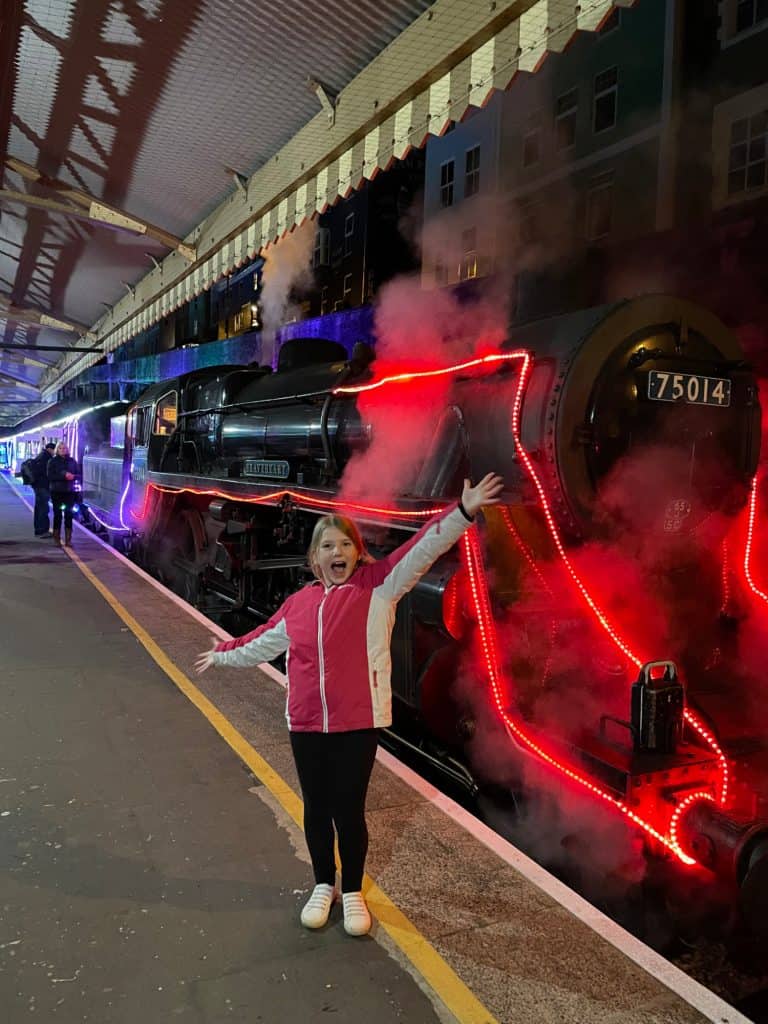 Girl in front of Train of Lights