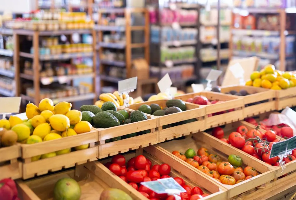 Fresh vegetables and fruits on counter in farm shop