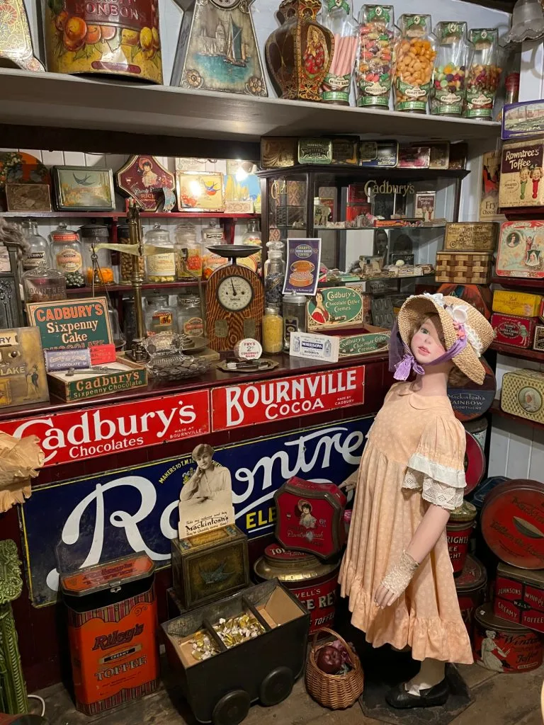 Child mannequin in Victorian clothes in sweet shop