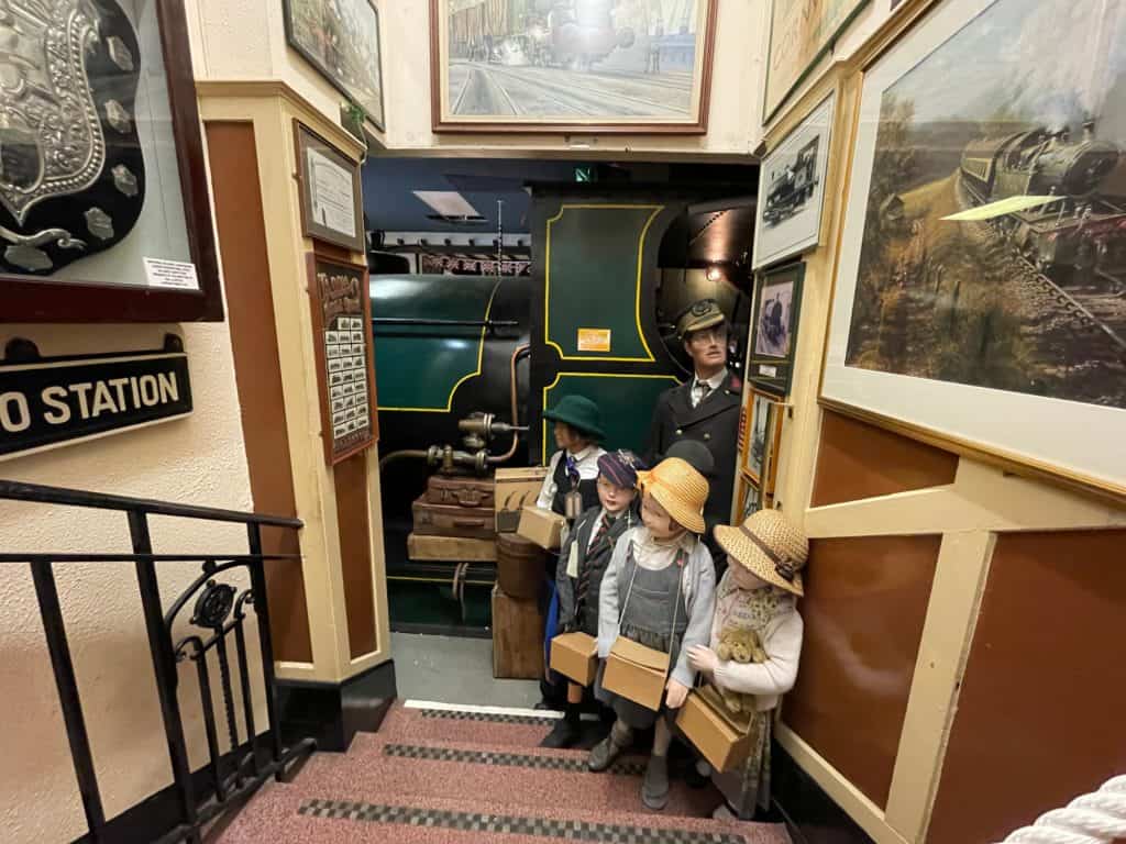 Models of evacuees and train conductor standing best train