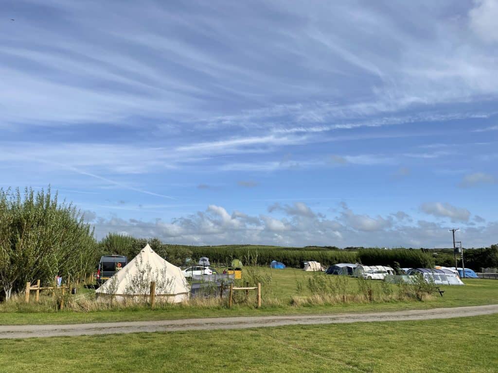 View of tents in fields at Lee Meadow Farm campsite