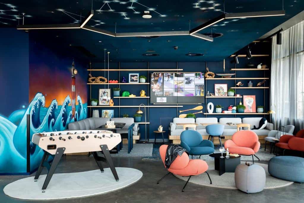 Vibrant lounge with table football and funky seating at Moxy Plymouth