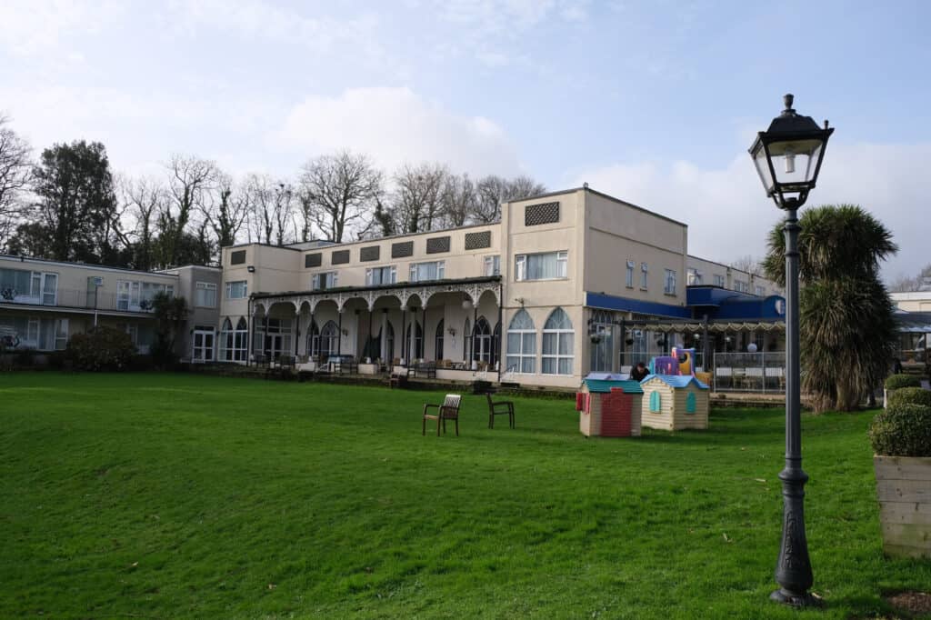 Children playing on the lawn in front of Langstone Cliff Hotel in Dawlish