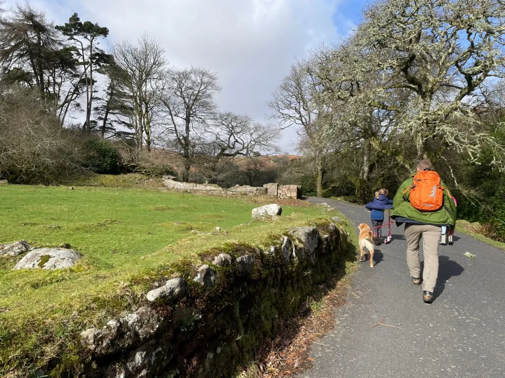 Family walking past stone ruins