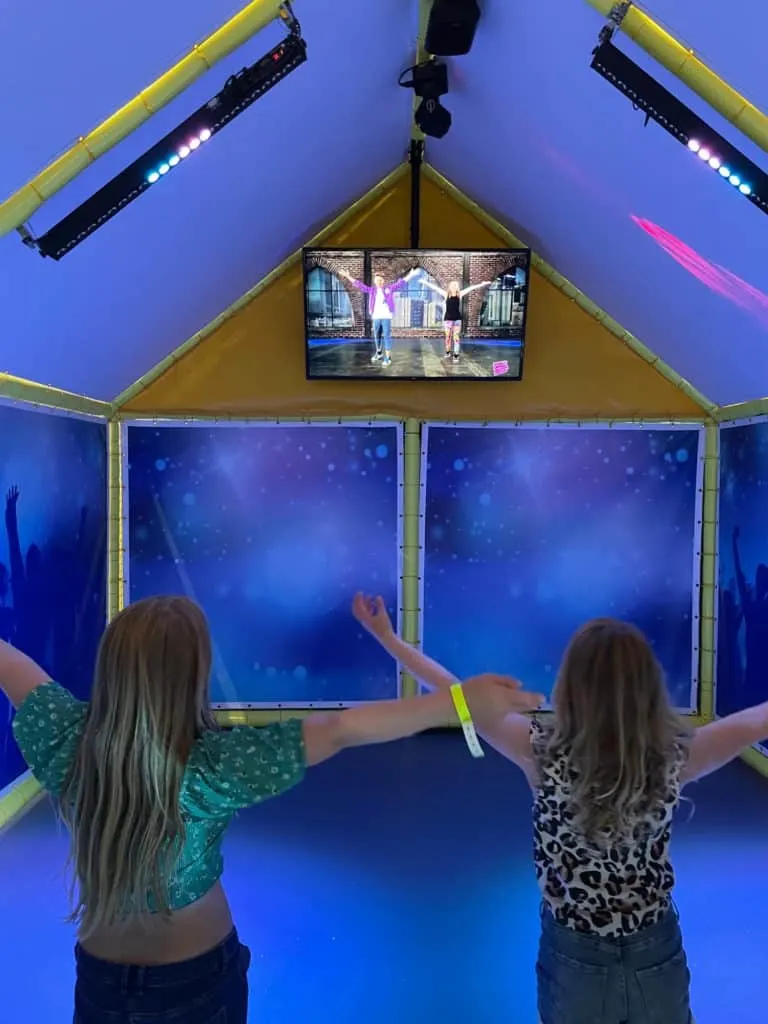 Children following dance moved on screen in Soo's Dance Studio