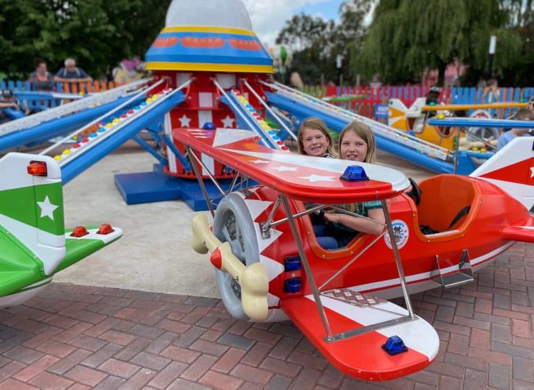 Children say in. the cockpit of a theme park ride plane