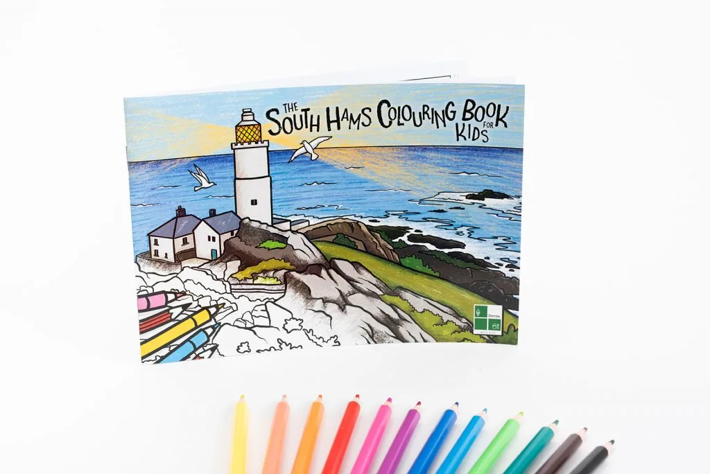 Cover of the South Hams Colouring Book for Kids with pencils fanned out below