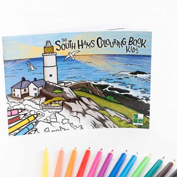 Cover of the South Hams Colouring Book for Kids with pencils fanned out below