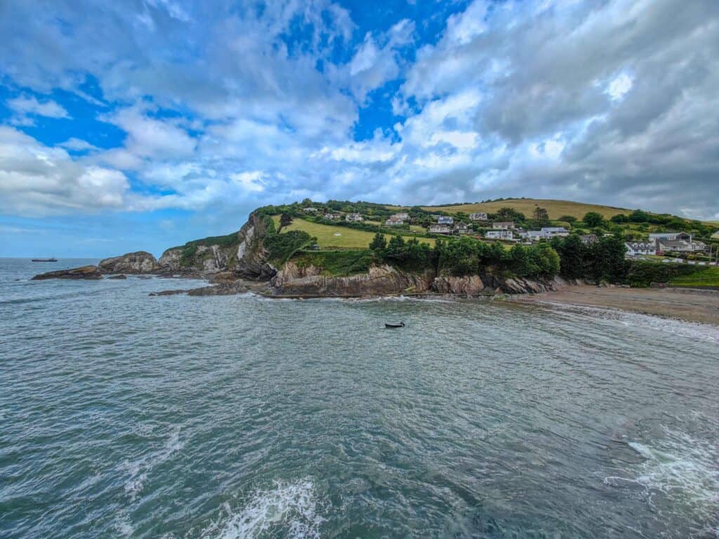 A view across the sea at Combe Martin with the beach and village to the right