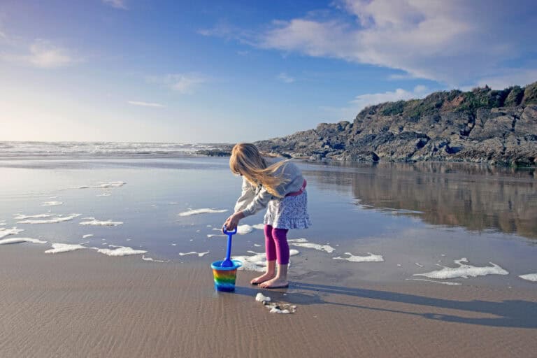 Girl with a bucket and spade on a beach in Woolacombe