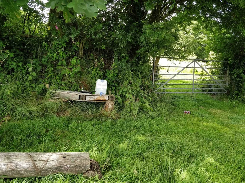 Mud kitchen under tree in grassy field