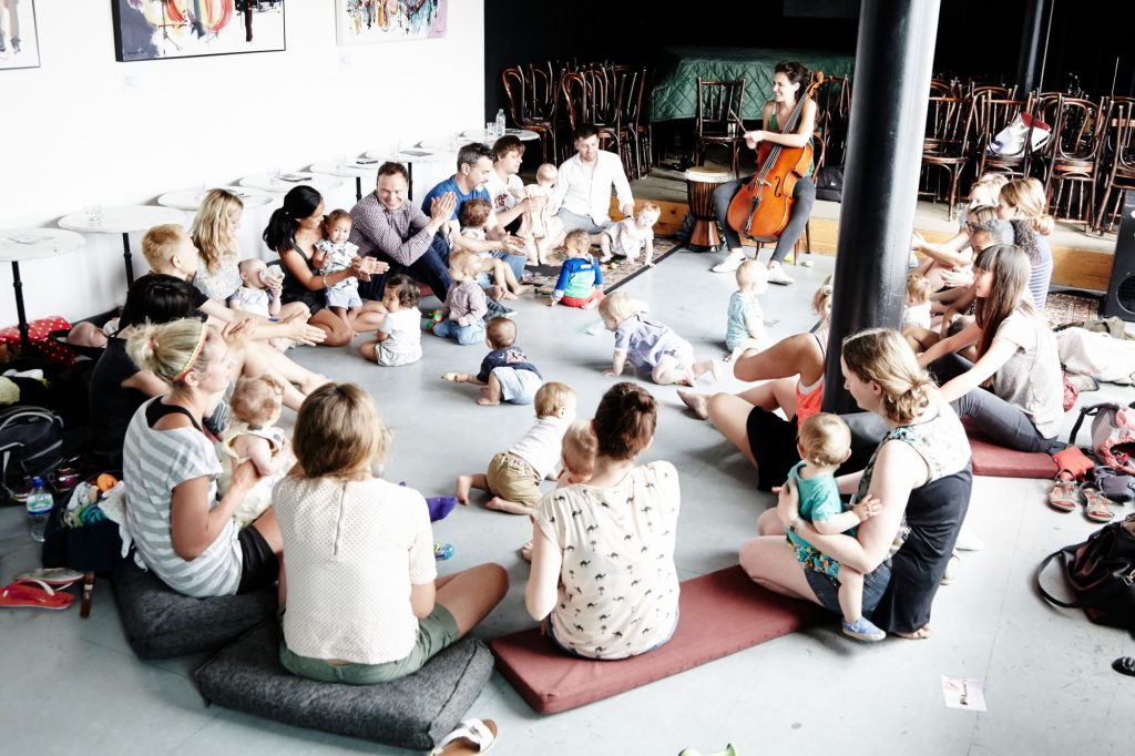 Families sat in circle at music workshop