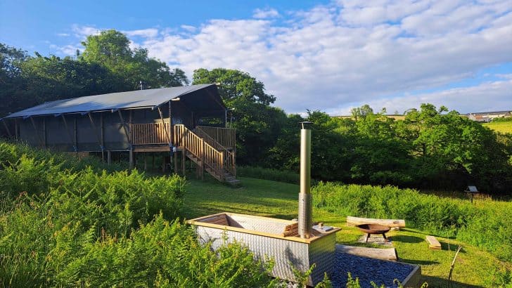 Glamping safari tent and wood fired hot tub in field at Bracenkhill Glamping in Devon