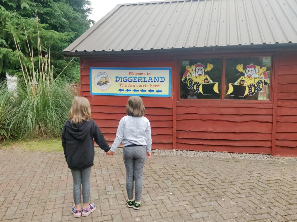 Children standing in front of entrance sign