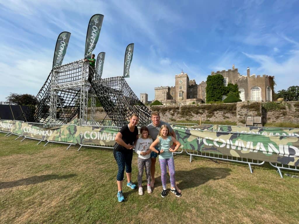 Family in front of Commando assault course at Powderham Castle