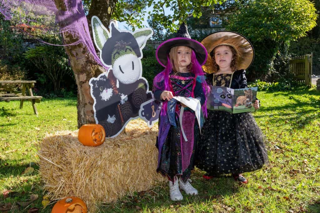 Children dressed as witches taking part in the Hide and Treat Halloween Hunt at The Donkey Sanctuary