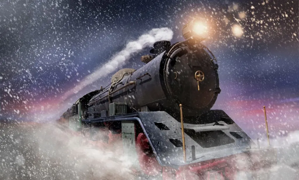 Polar Express train travelling through snow storm at twilight