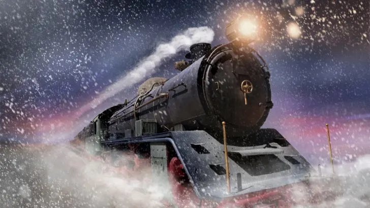 Polar Express train travelling through snow storm at twilight