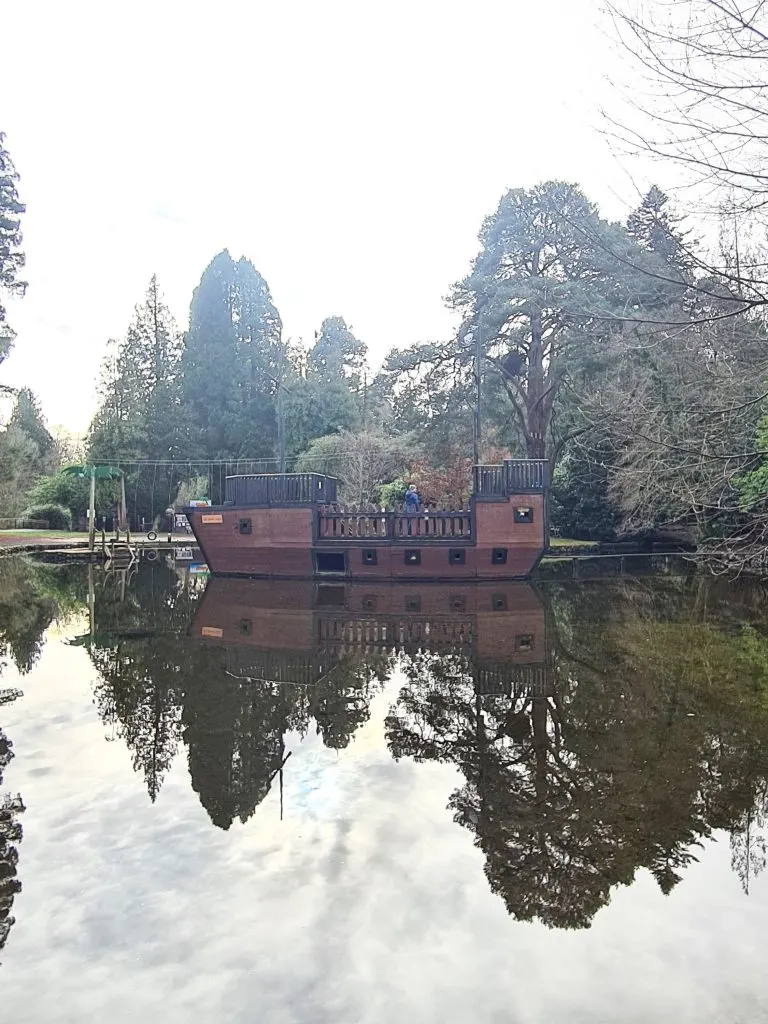 Pirate ship play feature in the middle of the swimming lake at River Dart Country Park
