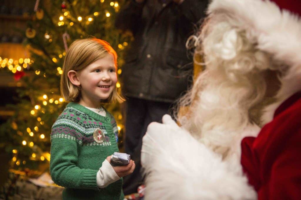 Child with Father Christmas at National Trust property