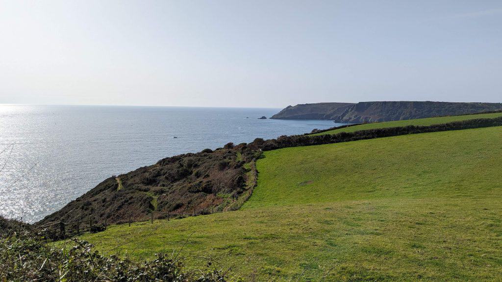A view of the South Devon coastline from the South West Path on a sunny day