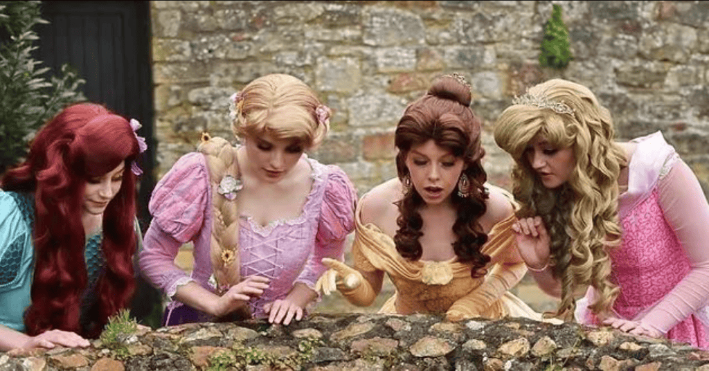 Four fairytale princesses look over a wall 