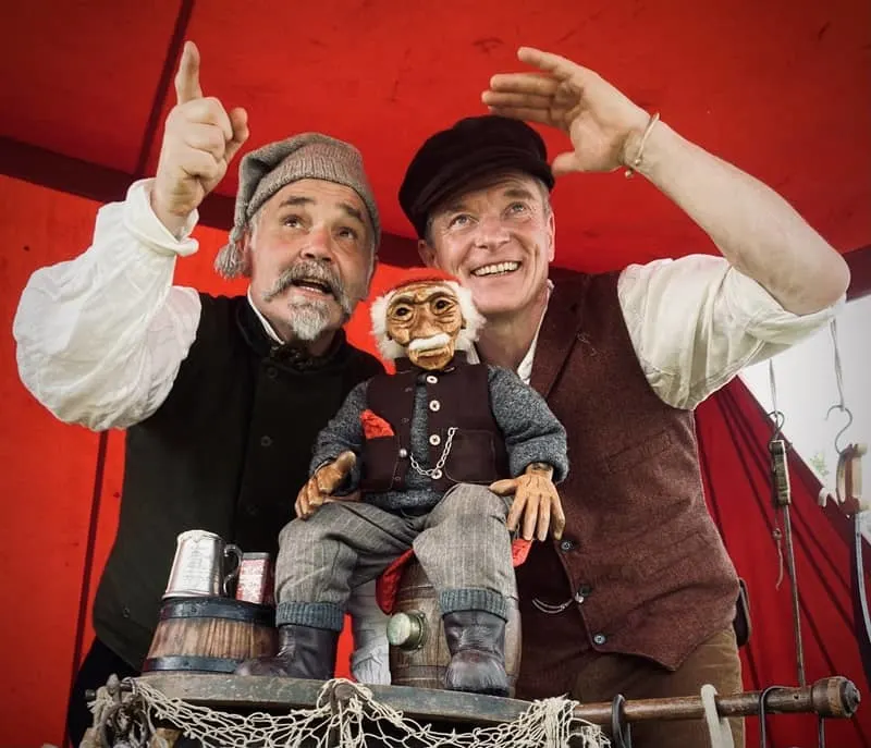Actors dressed as pirates with a pirate puppet
