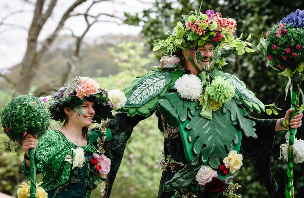 Street artists dressed as woodland nymphs with foliage themed outfits