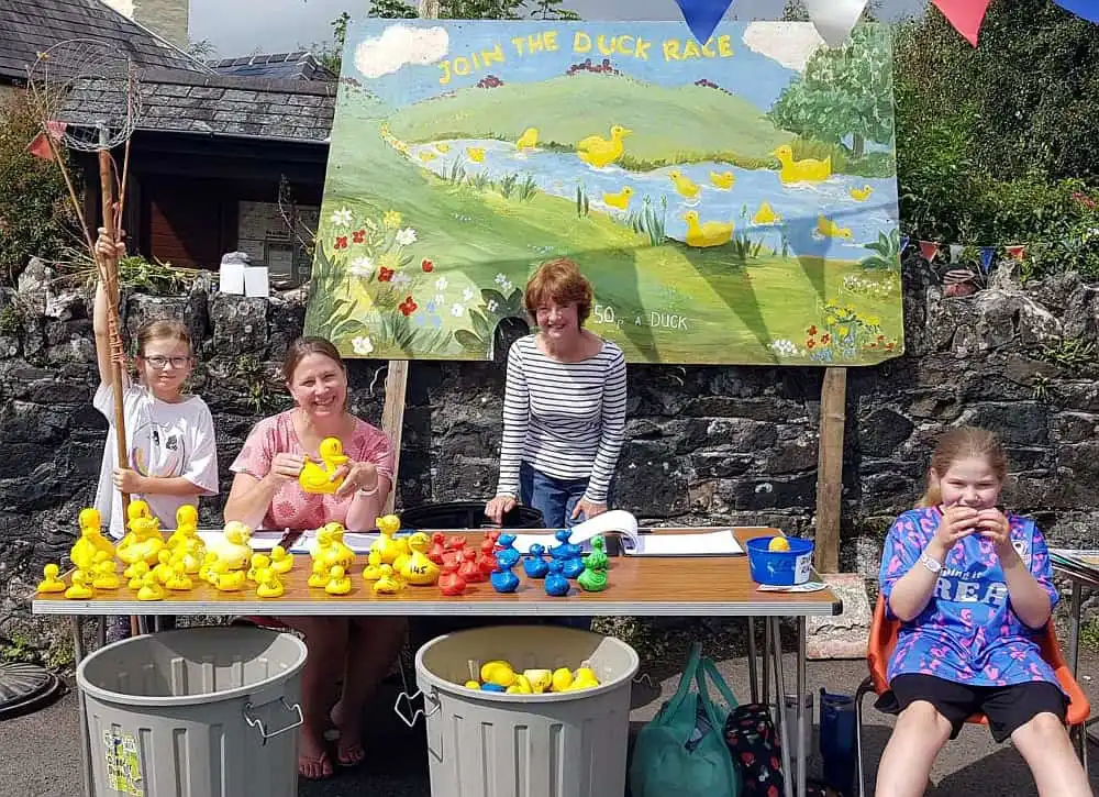 Duck race stall with volunteers ready to see ducks to take part in the race