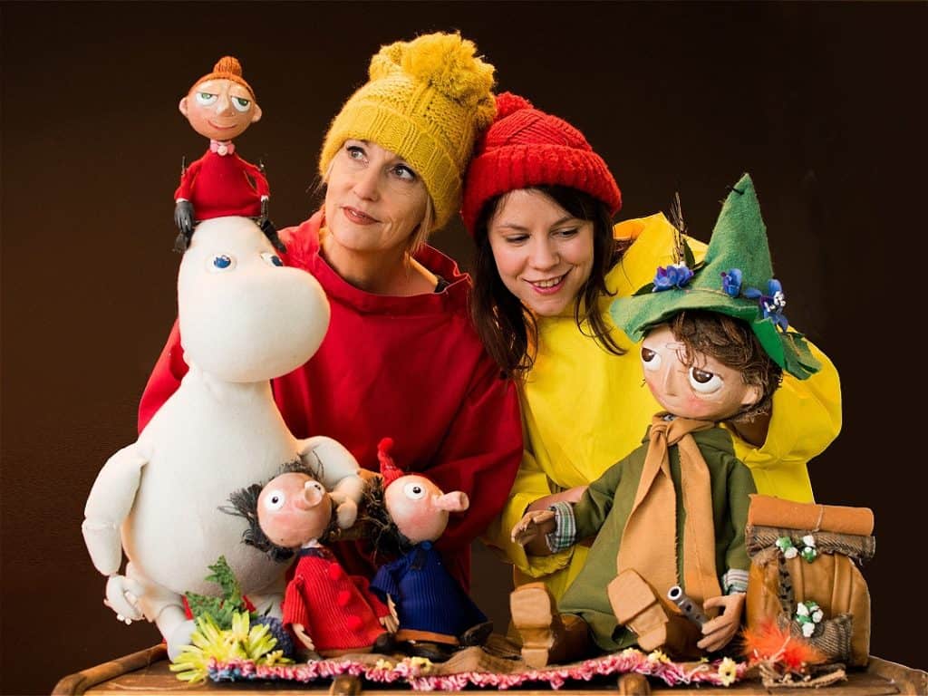 Two puppeteers with puppet characters from the Moomins