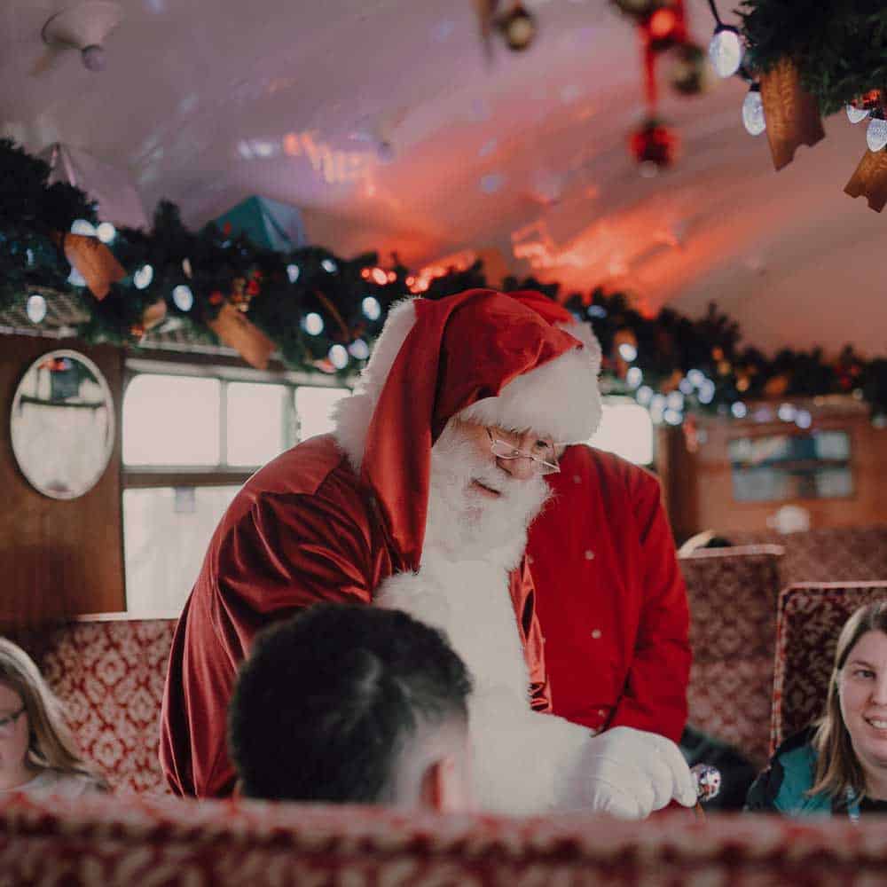 Santa talking to passengers onboard a train on South Devon Railway