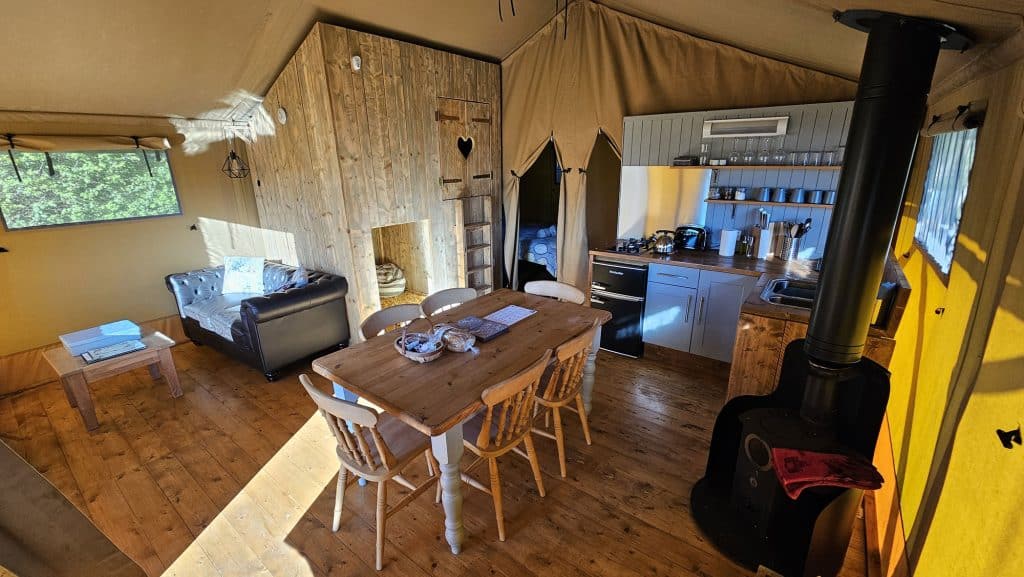 The dining area and kitchen inside Birch glamping safari tent