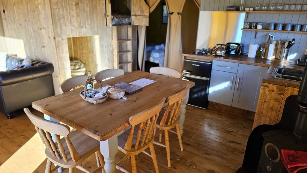 The dining area and kitchen inside Birch glamping safari tent