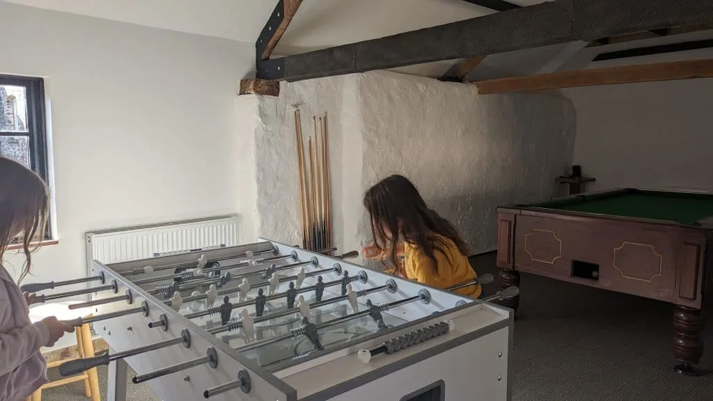 One of Stacey's daughters playing tale football in the games room
