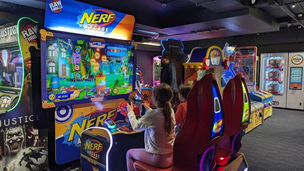 Stacey's children playing on arcade games at Cofton Holidays in Devon