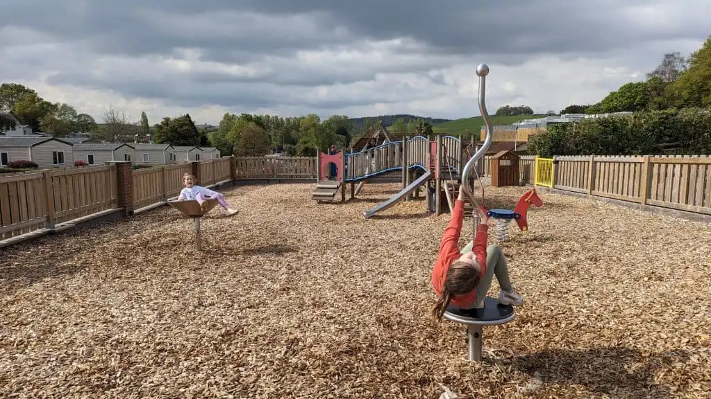 Stacey's children on the outdoor playground at Cofton Dawlish in South Devon