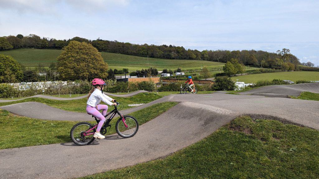 Stacey's daughter on a bike on the pump track at Cofton Holidays in Dawlish, South Devon