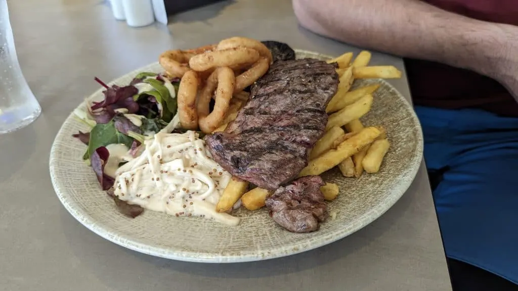 Steak, salad, onion rings and chips meal at Amelia's Restaurant at Cofton Holidays in Dawlish, Devon