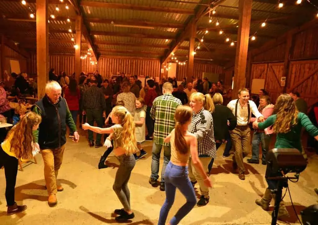 Families dancing in a barn