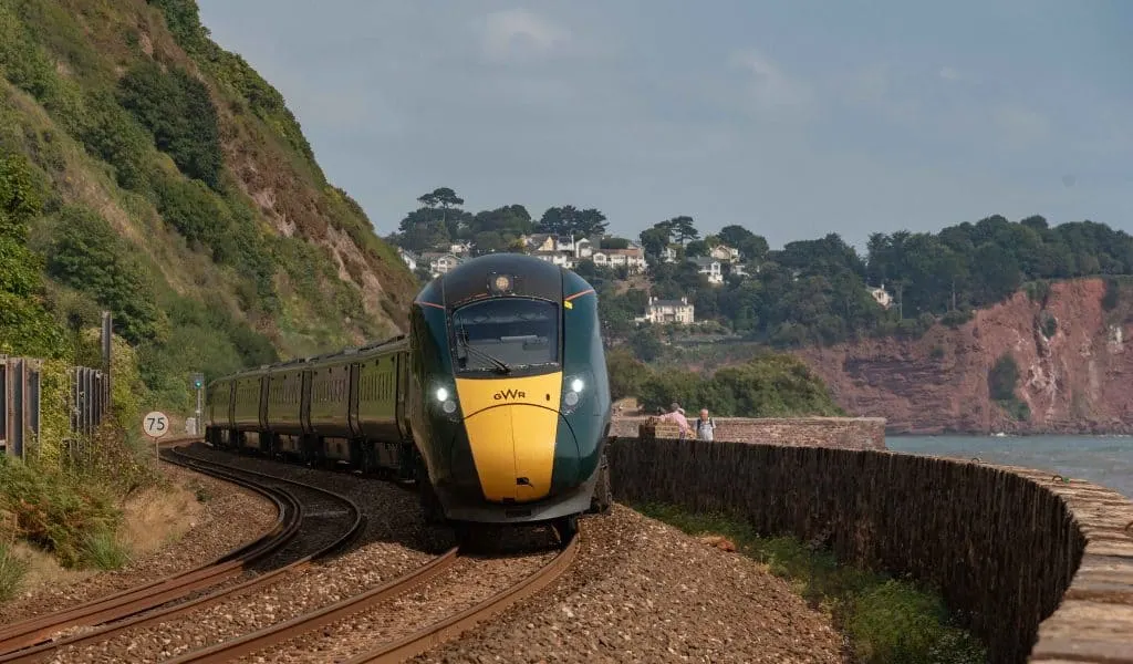 Teignmouth, Devon, England, UK. 2022. Passenger train approaching Teignmouth, from Dawlish, Devon along the south west coast line.