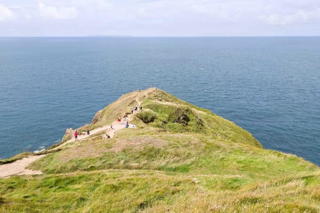 Visitors walking around the Baggy Point Zealand near Croyde, North Devon, England