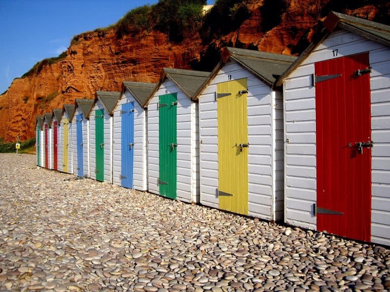 Colourful beach huts along the red cliffs at Budleigh Salterton beach in East Devon