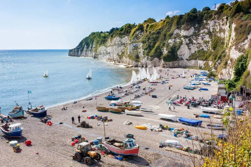 Overlooking the beach and cliffs at Beer in East Devon. there are fishing and rowing boats along the shore