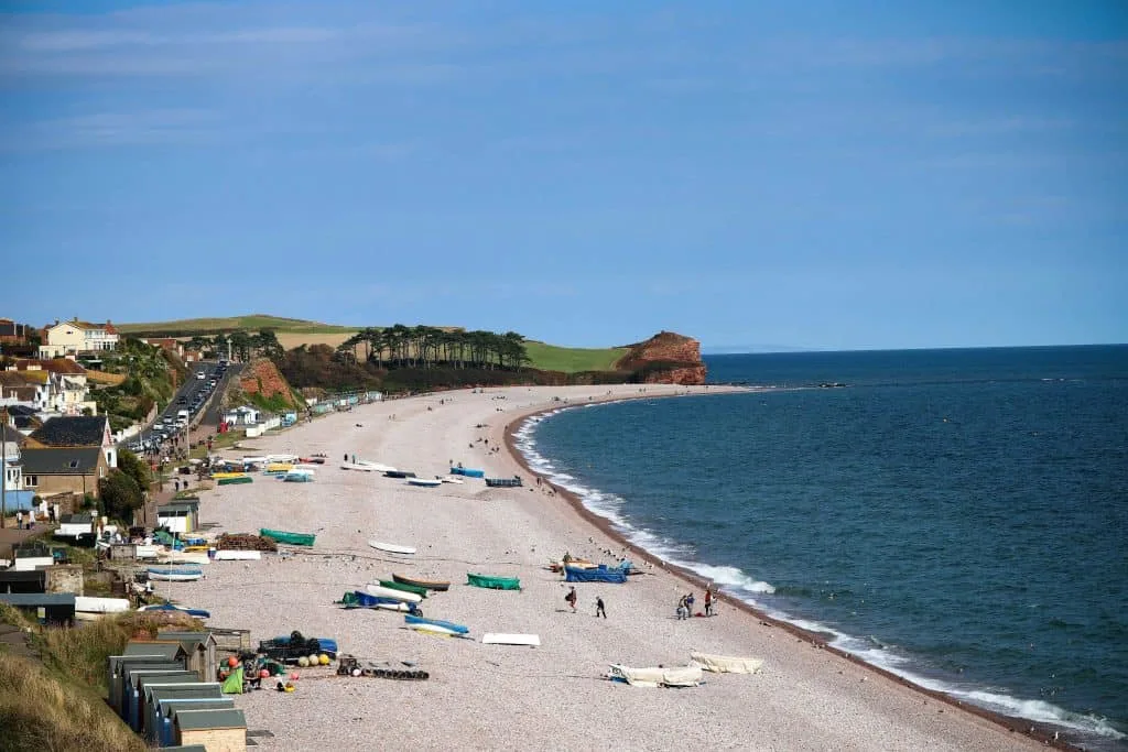 The single shoreline of Budleigh Salterton Beach with boats pulled up