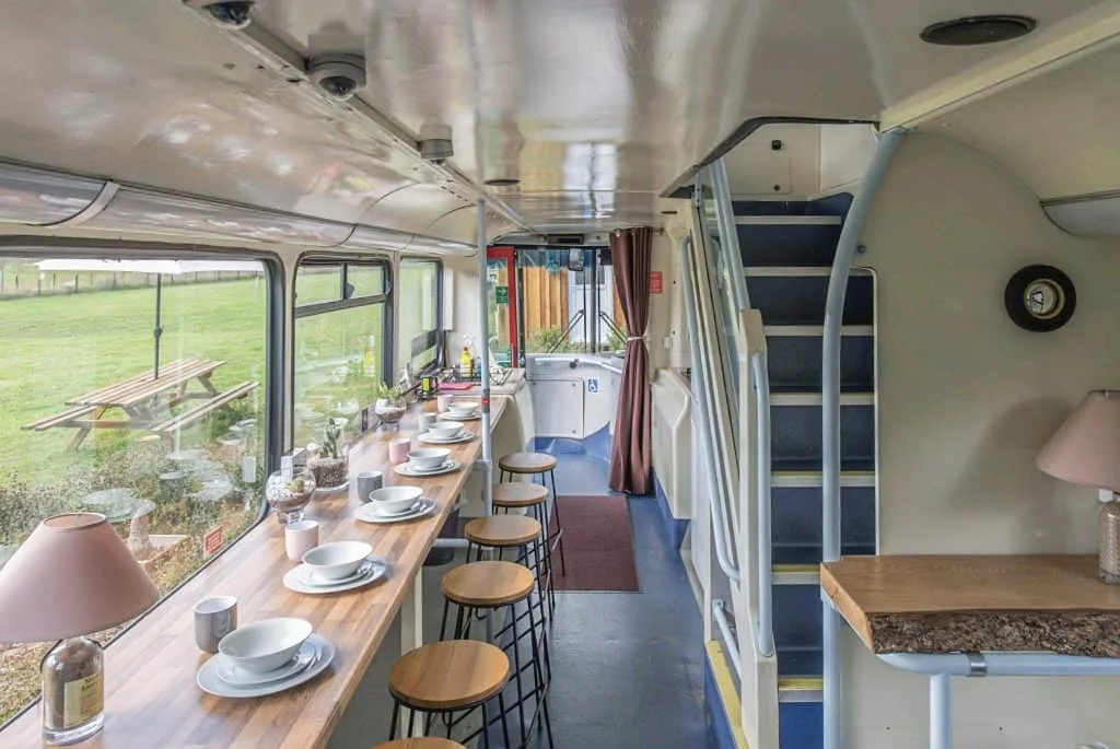 Inside the lower deck of the Red double decker bus converted into glamping accommodation