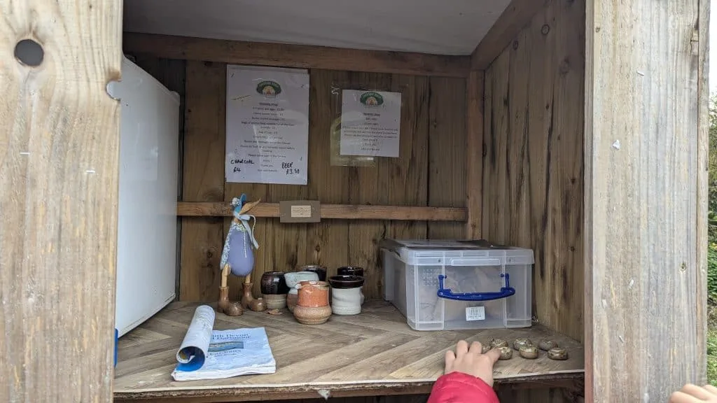 The campsite honesty shop with eggs, bacon, sausages, animal feed, logs, charcoal and beer on sale