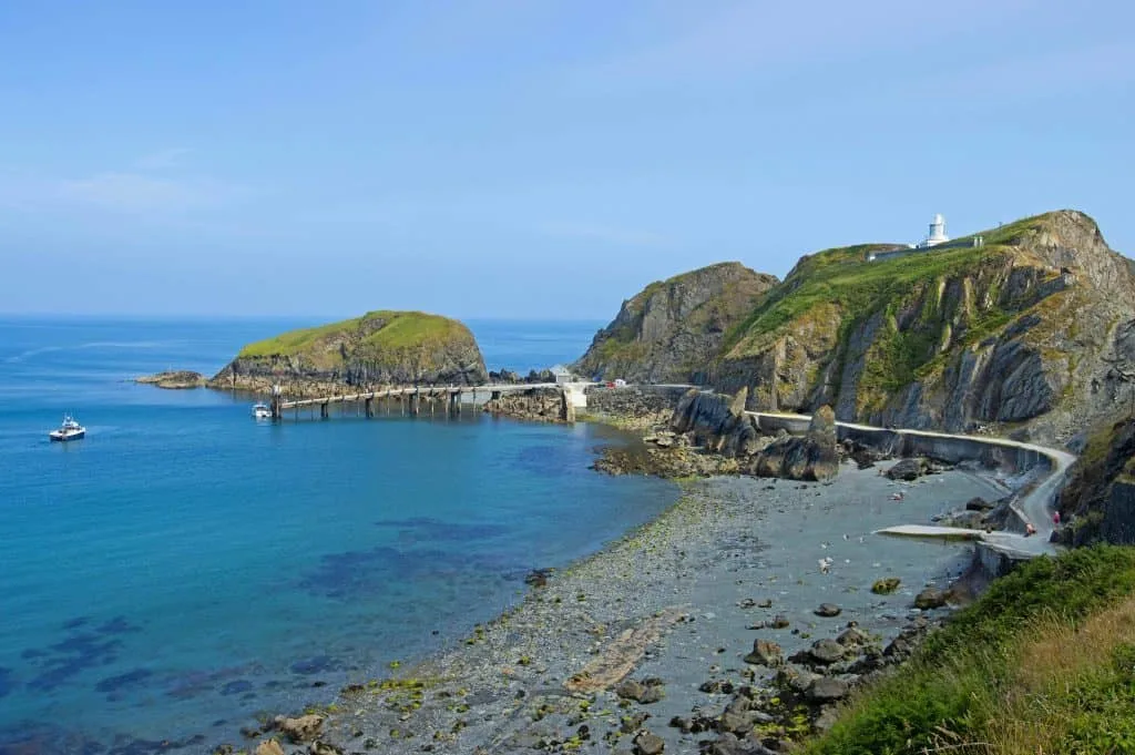 Elevated view of the landing bay of the Lundy Island and Lundy South Lighthouse in the Bristol Channel in tranquil day