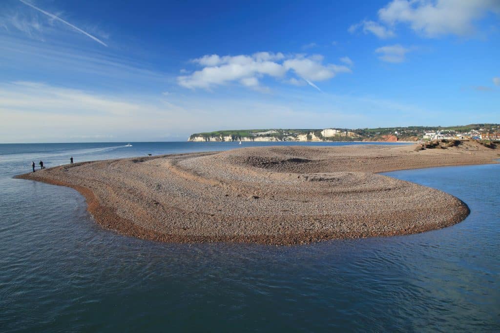 The shingle spit at the end of Seaton Beach in East Devon where the river flows into the sea